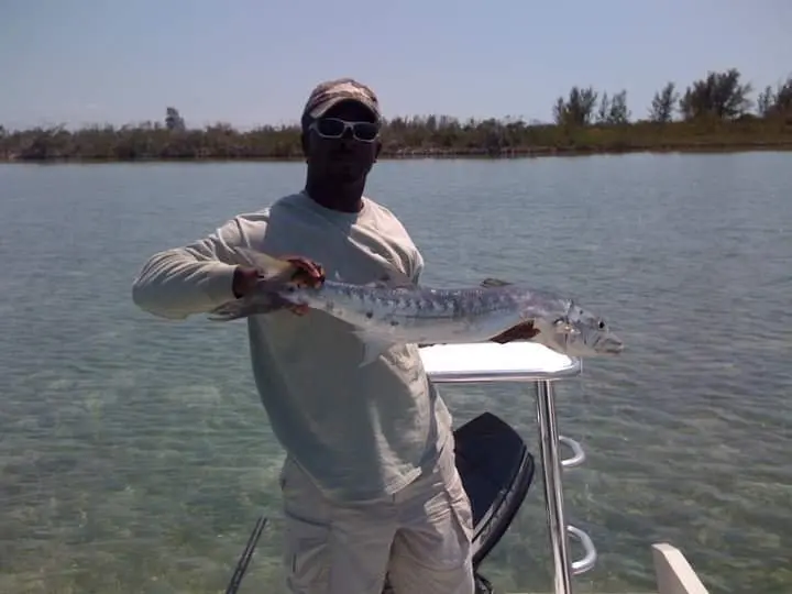Grand Bahama fishing guide David Tate holding a bonefish