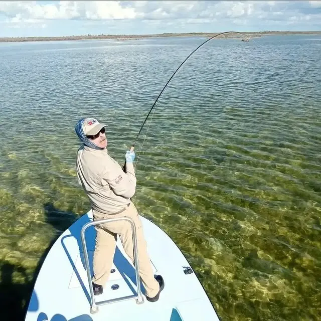 Angler casting from a flats skiff in Grand Bahama