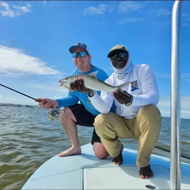 Angler and guide holding a bonefish on the Grand Bahama flats